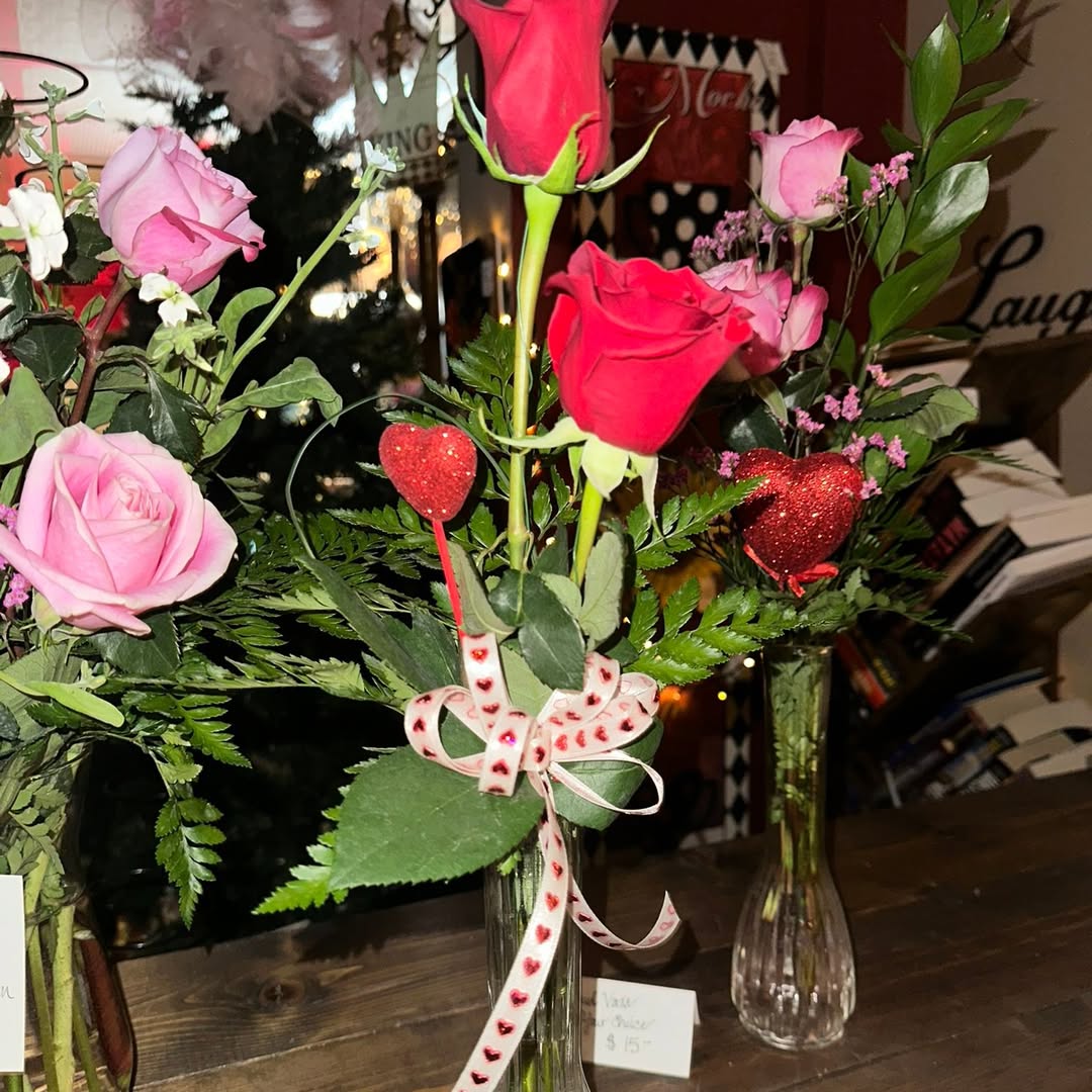 Pink and red rose arrangements in glass vases